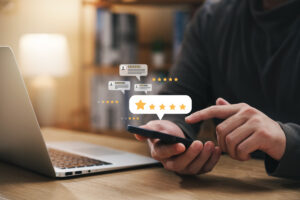 Man reading through 5-star reviews on his phone and computer