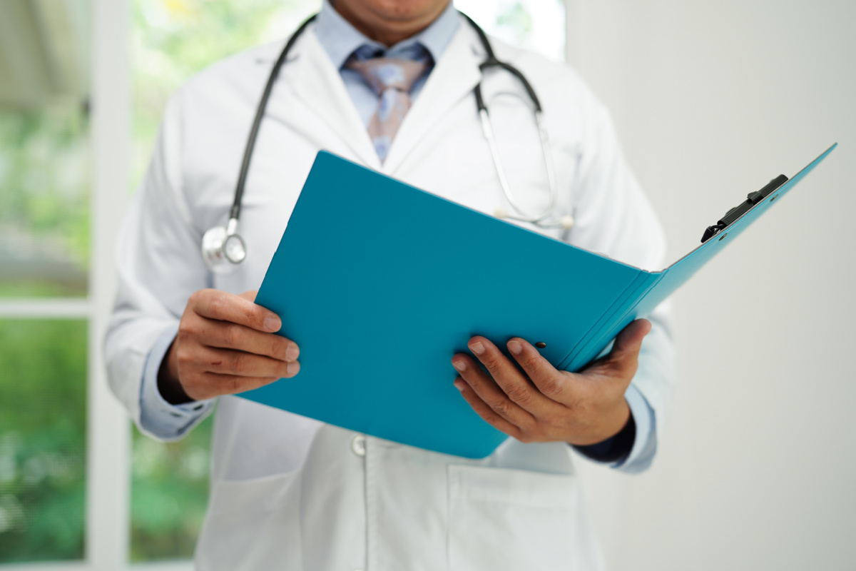 Doctor holding folder with patient information