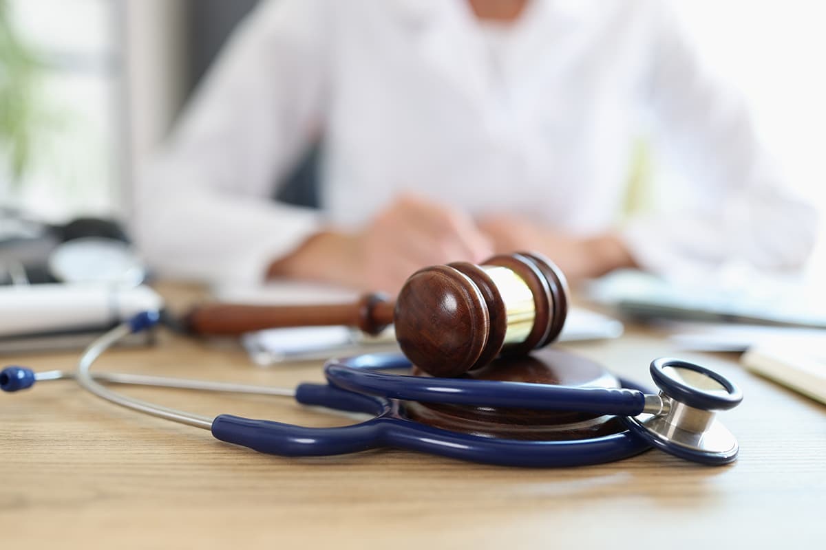 Medical law concept with gavel and stethoscope on desk