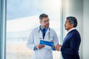 Male doctor talking to a man in a suit