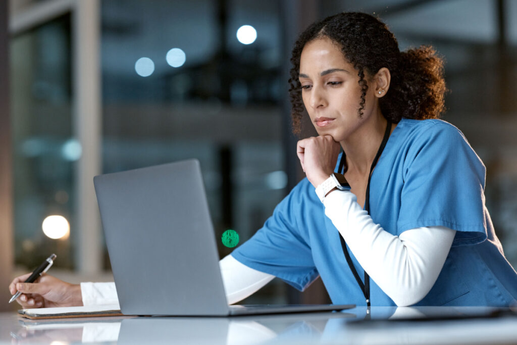 Female medical professional on laptop late at night