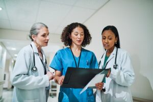 Medical team referencing paperwork and records