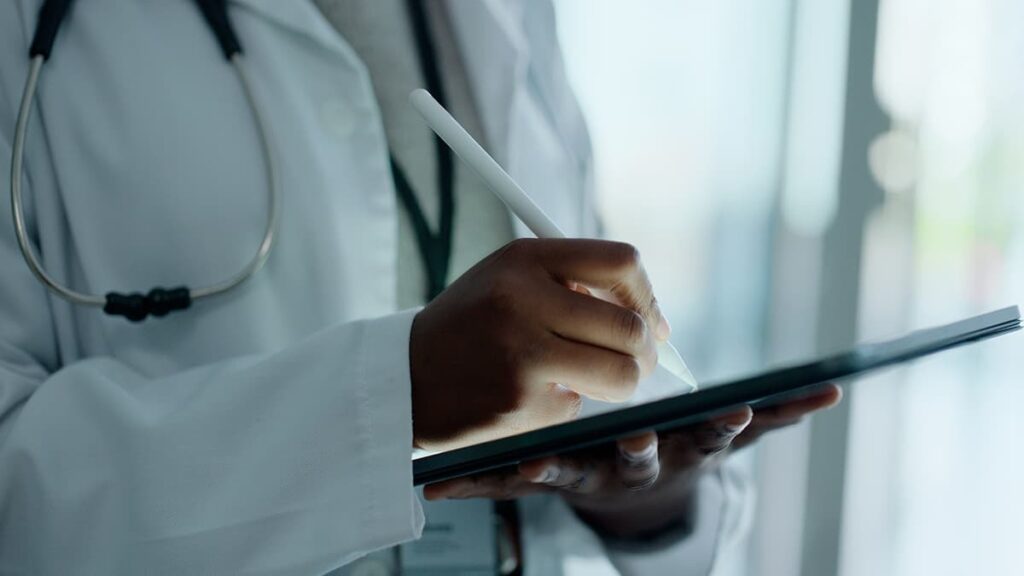 Doctor taking notes on a tablet