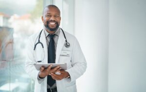 Smiling doctor with tablet