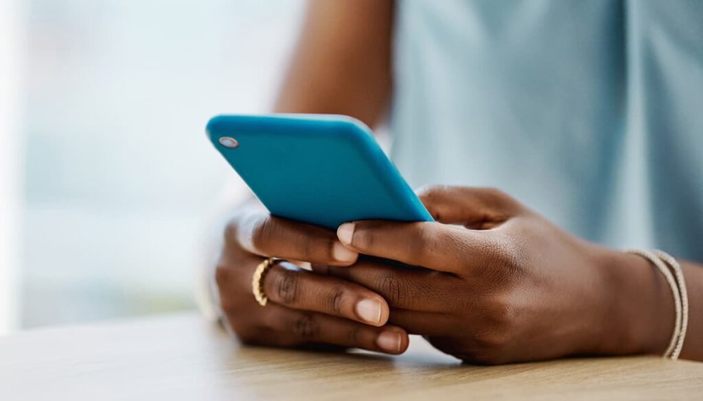 Close up of woman with blue camera phone