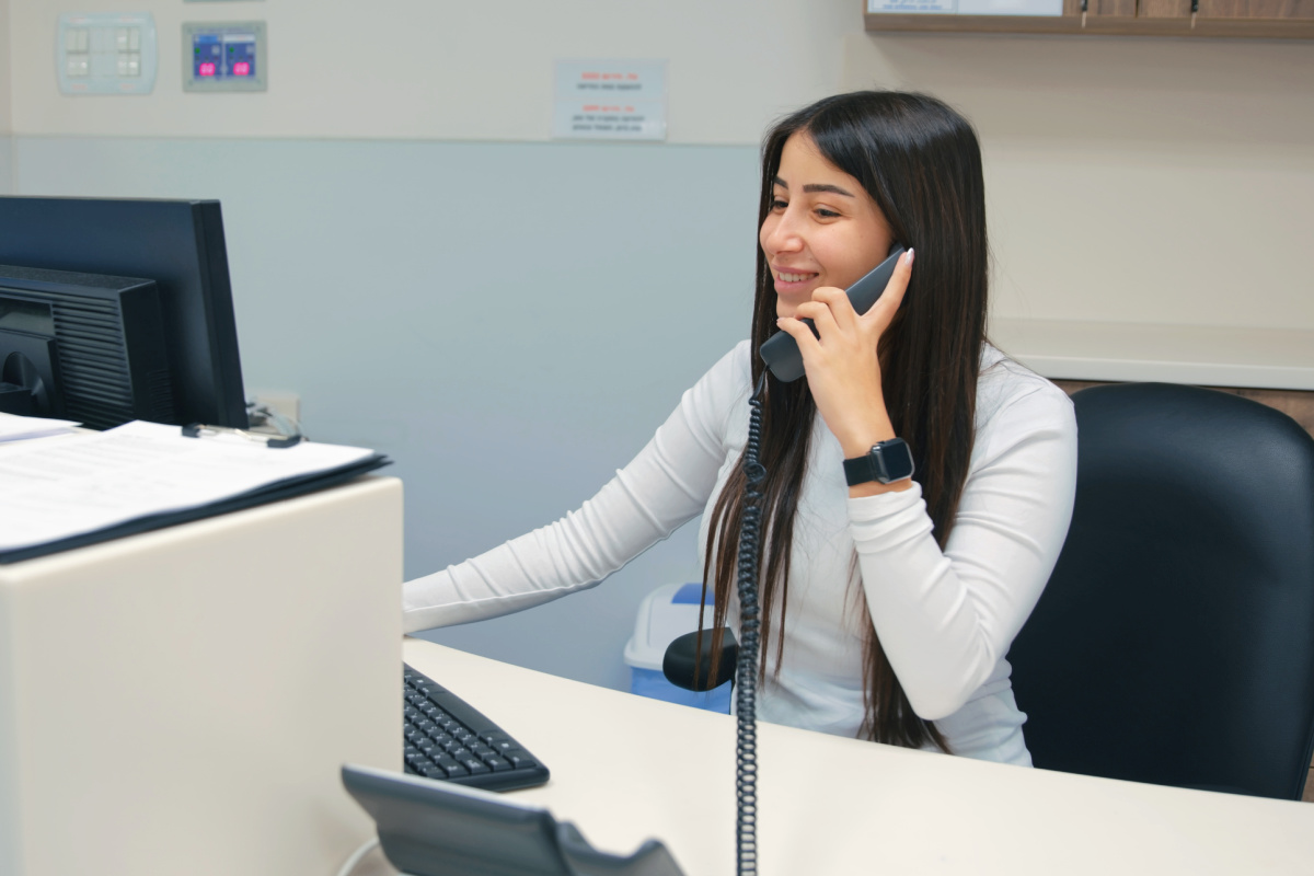 Young receptionist answering the phone at a medical practice