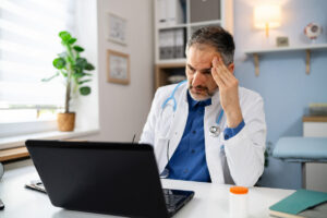 Frustrated doctor dealing with angry patient online