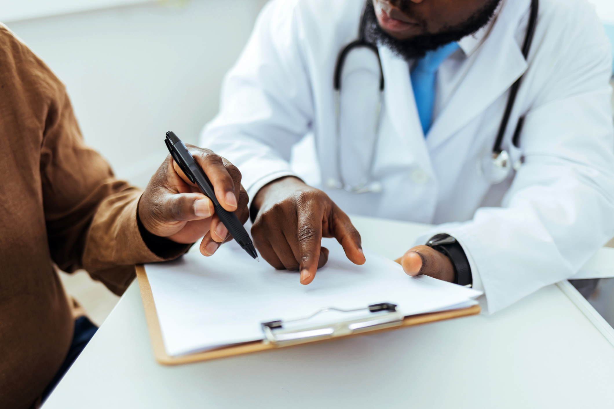 Doctor having patient sign a form