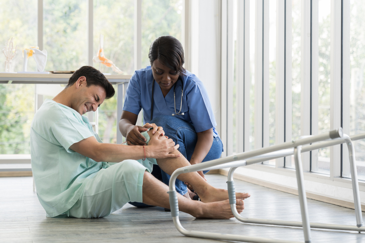 Doctor helping patient who has fallen