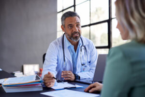 Male doctor having conversation with new patient