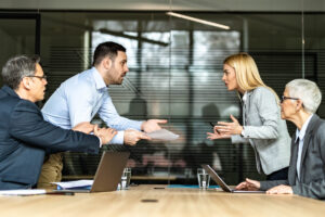 Man and woman arguing over documents with their lawyers
