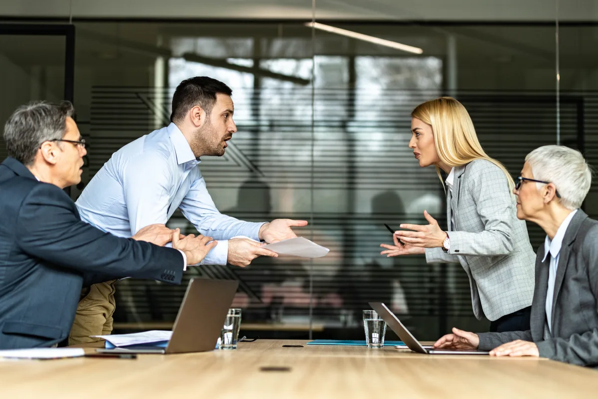 Man and woman arguing over documents with their lawyers