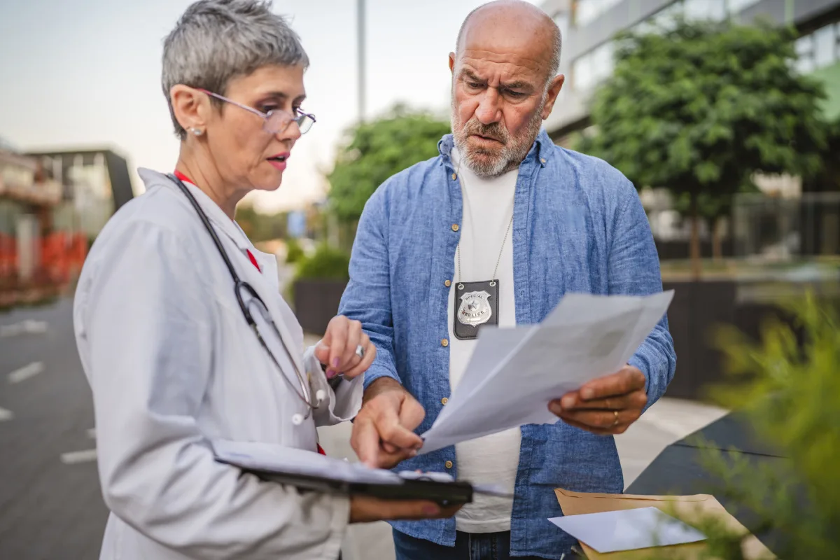 Female physician talking to an ICE federal agent outside of her medical practice