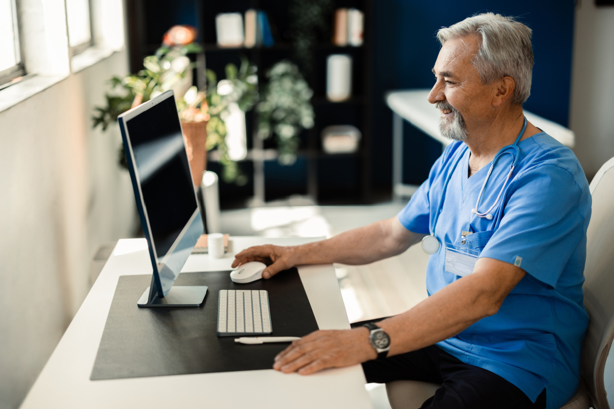 Senior doctor learning to use AI tools in his medical practice