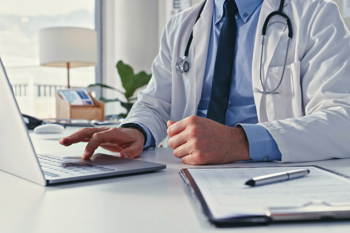 Doctor using AI to de-identify protected health information (PHI)