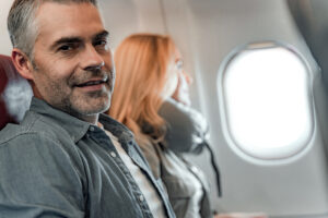Man on board a crowded airplane
