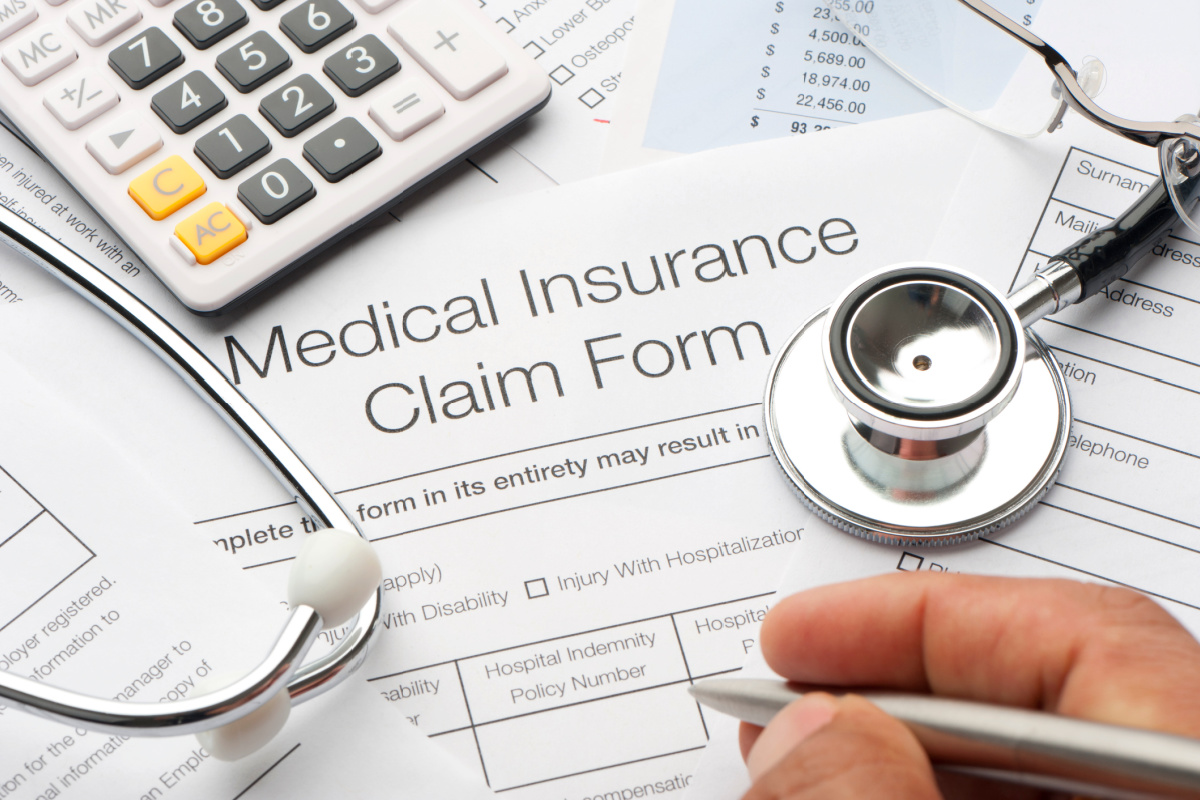 Close up of medical insurance claim form and calculator