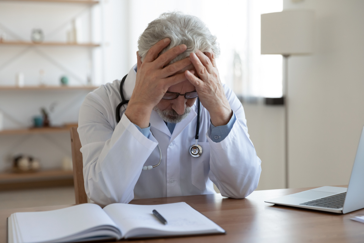 Distressed male physician dealing with a frivolous lawsuit