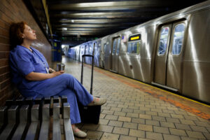 Female physician commuting home from work in New York
