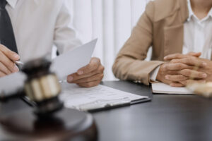 Physician with defense attorney during malpractice settlement