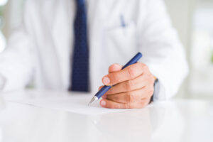 Physician signing legal contract